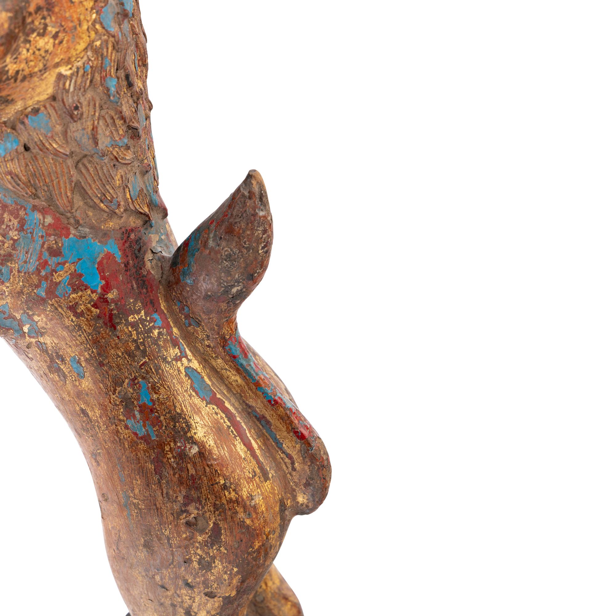 A Pair of Parcel-Gilt and Polychrome Decorated Lion-Form Crest Supporters