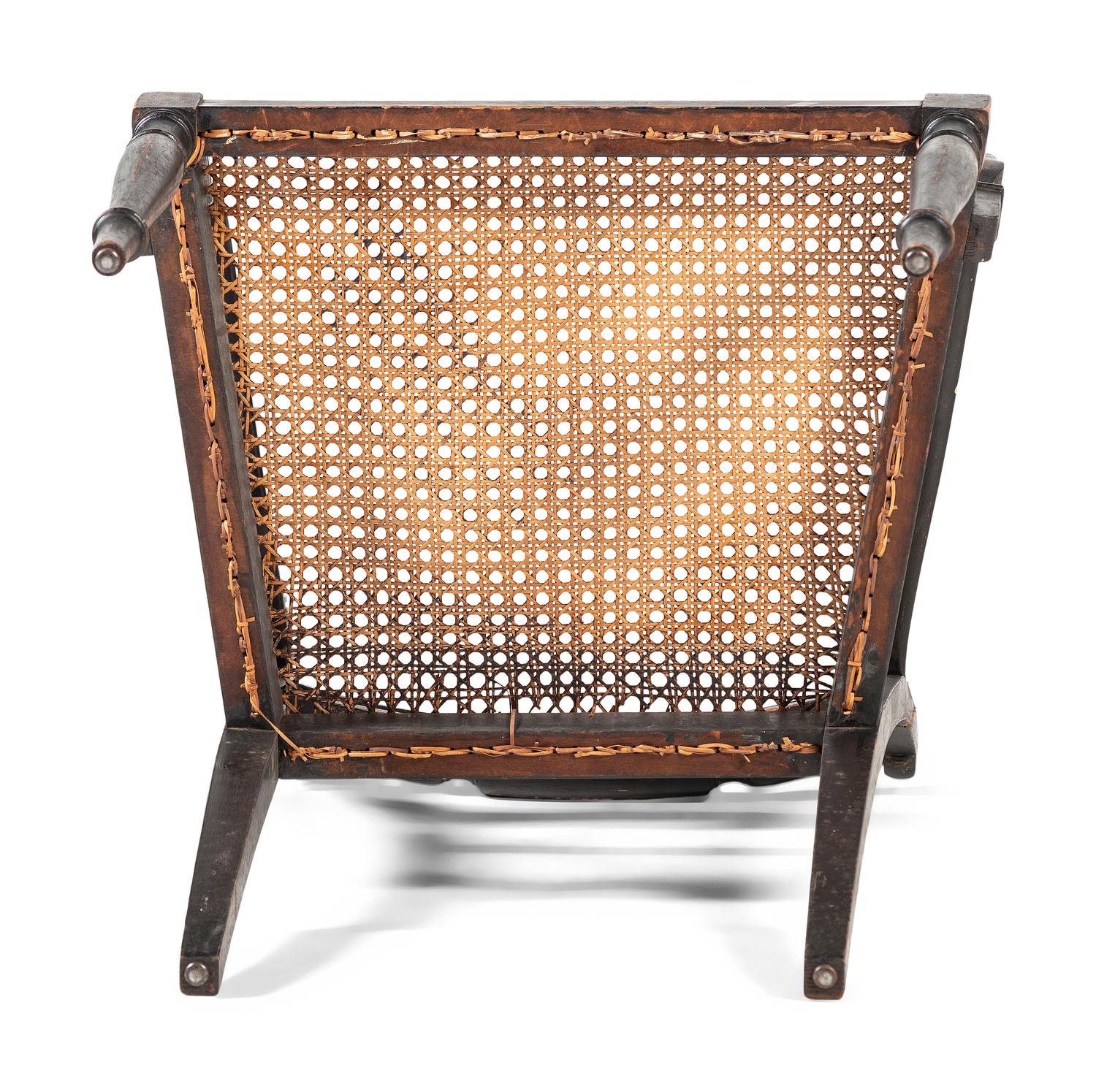 A Classical Black and Gilt Decorated Cane-Upholstered Armchair
