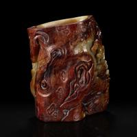 A Chinese carved russet and celadon jade brush holder 青玉笔筒