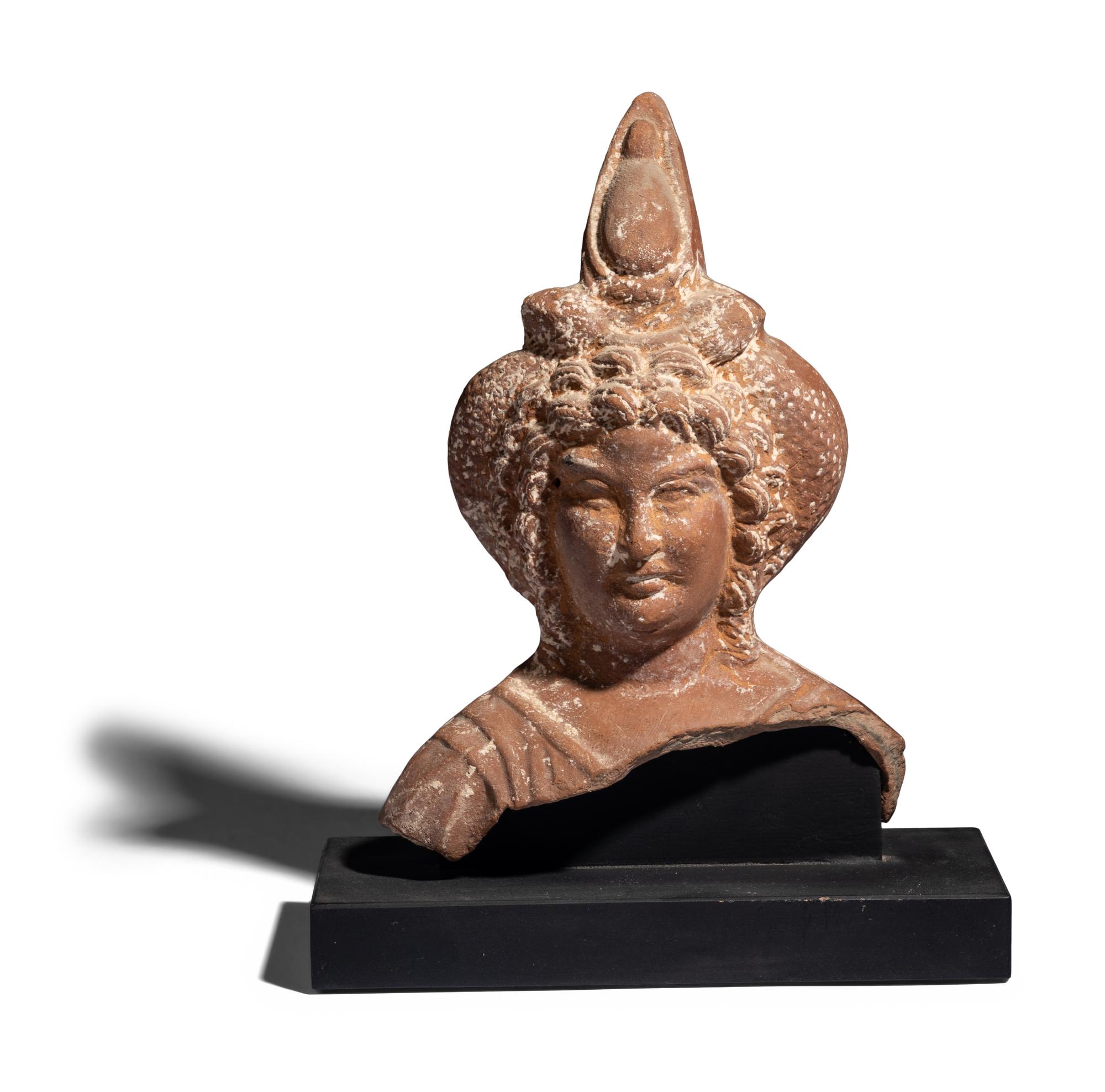 An Egyptian Terracotta Head of Harpocrates