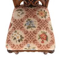 A Set of Six Rococo Revival Carved Oak Dining Chairs