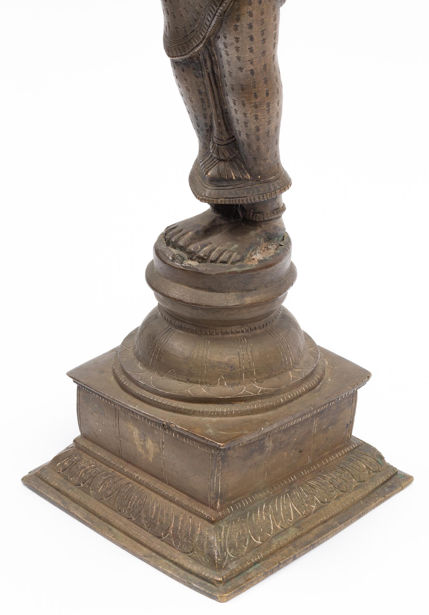 An Indian Patinated Metal Figure of a Standing Deity