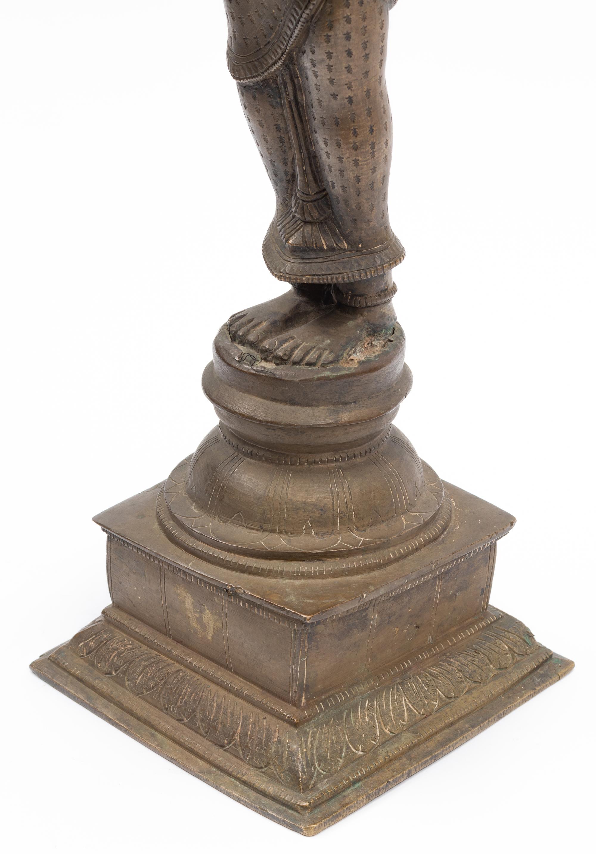 An Indian Patinated Metal Figure of a Standing Deity