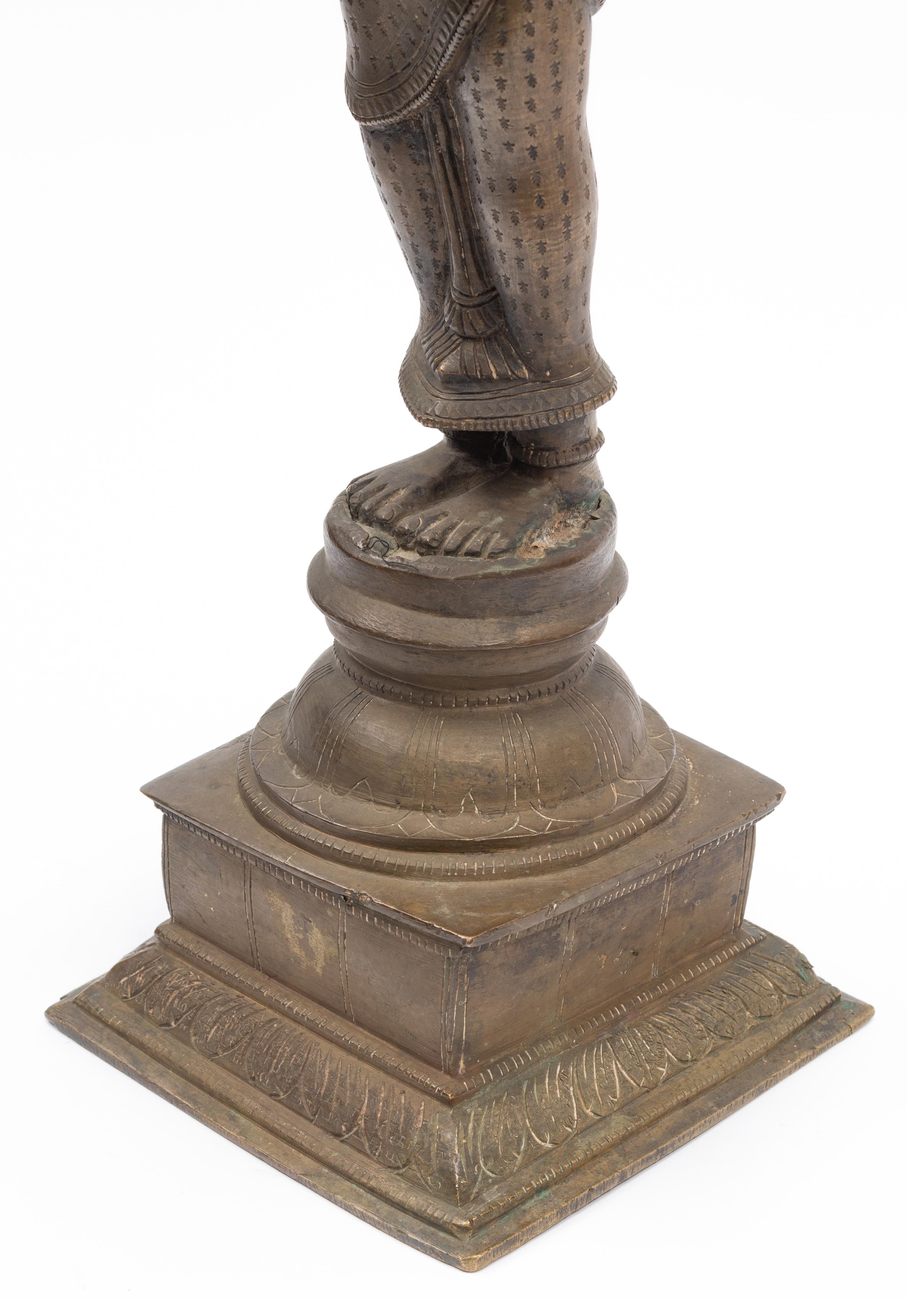 An Indian Patinated Metal Figure of a Standing Deity