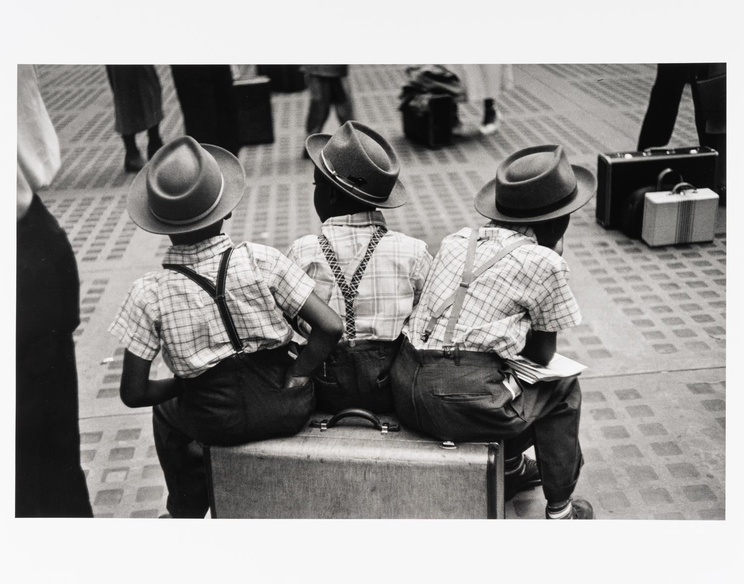 Ruth Orkin (1921-1985) Three Boys on a Suitcase, Penn Station, New York City, 1947