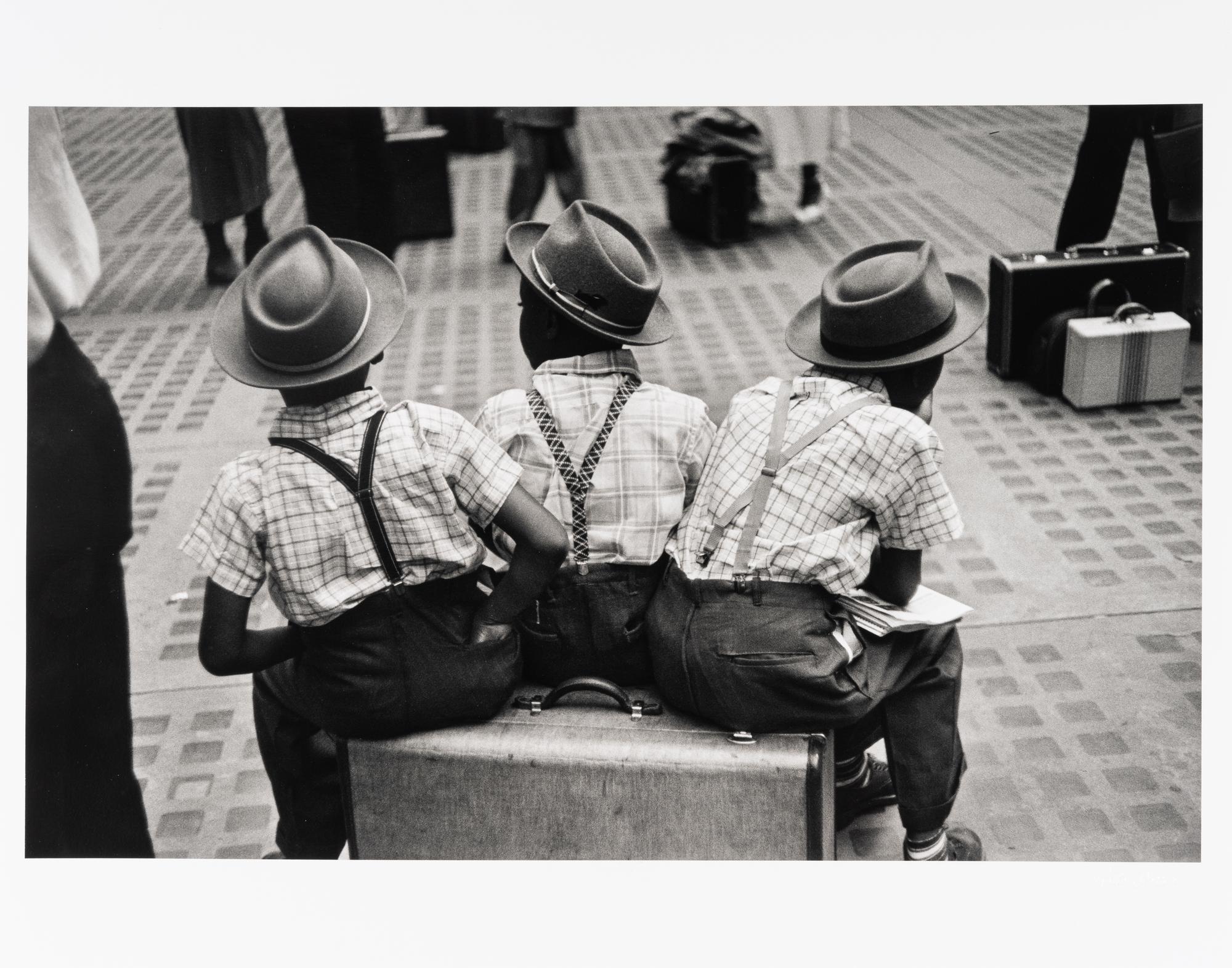 Ruth Orkin (1921-1985) Three Boys on a Suitcase, Penn Station, New York City, 1947