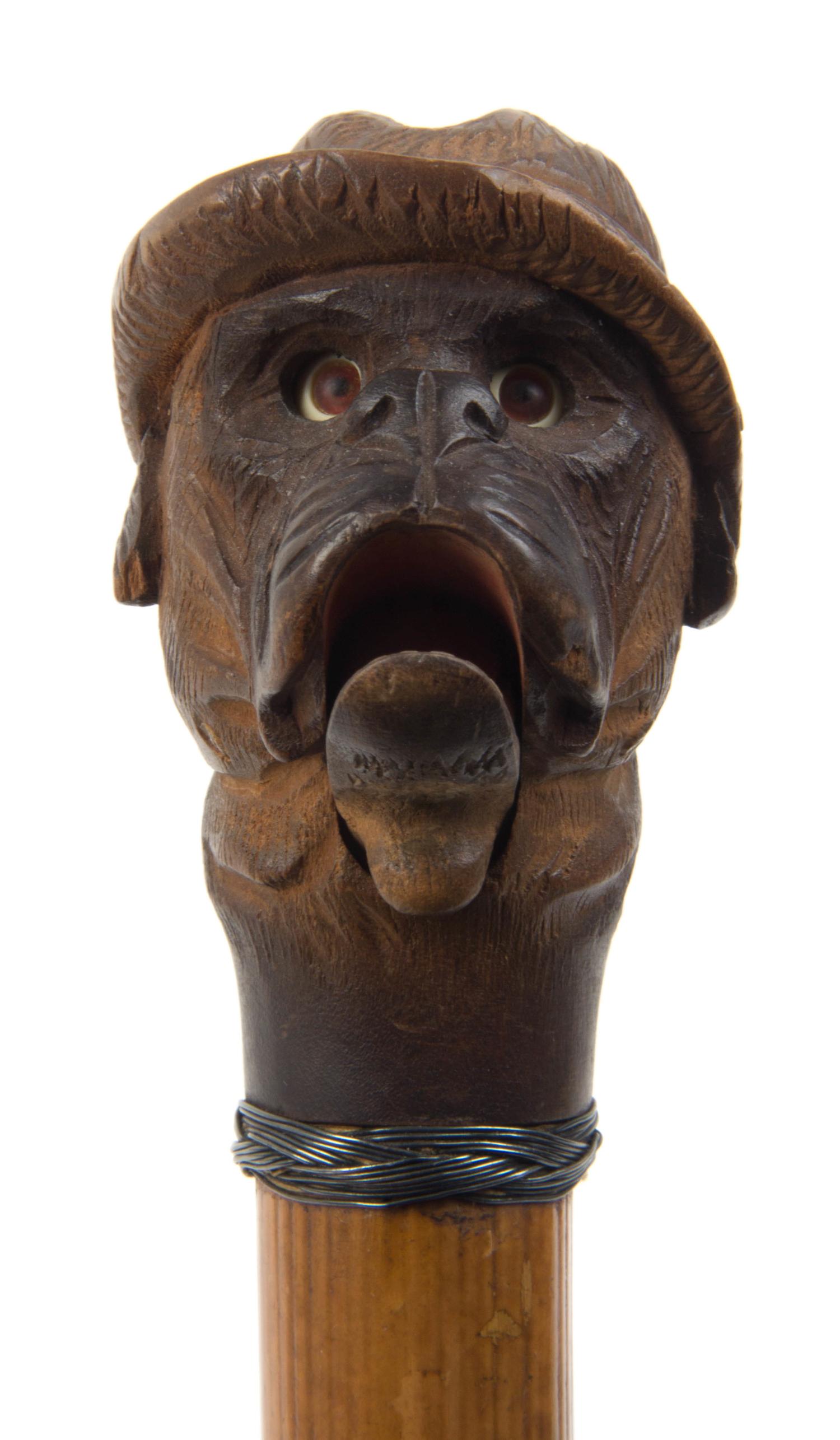 An American Carved Wood Glove Holder Cane, Length overall 35 1/2 inches.