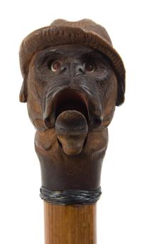 An American Carved Wood Glove Holder Cane, Length overall 35 1/2 inches.