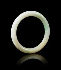 An Apple Green and Celadon Jadeite Bangle Diameter 3 3/4 inches.