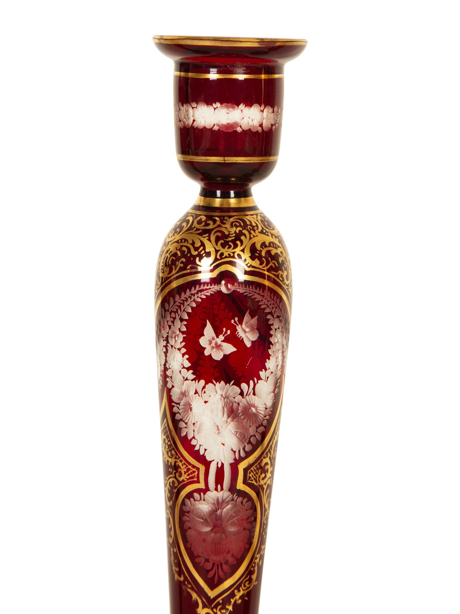 A Set of Four Bohemian Ruby Cut-to-Clear Glass Candlesticks with Gilt Decoration. — 19th Century