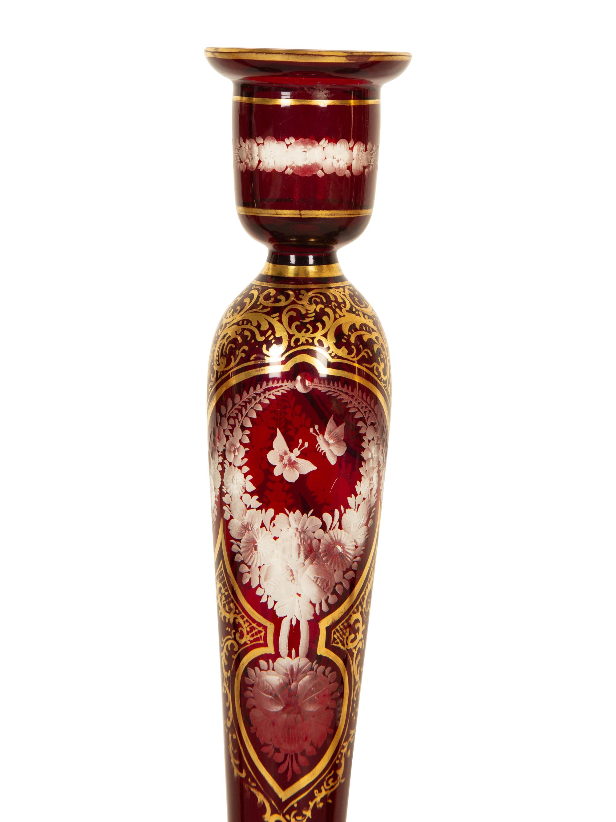 A Set of Four Bohemian Ruby Cut-to-Clear Glass Candlesticks with Gilt Decoration. — 19th Century