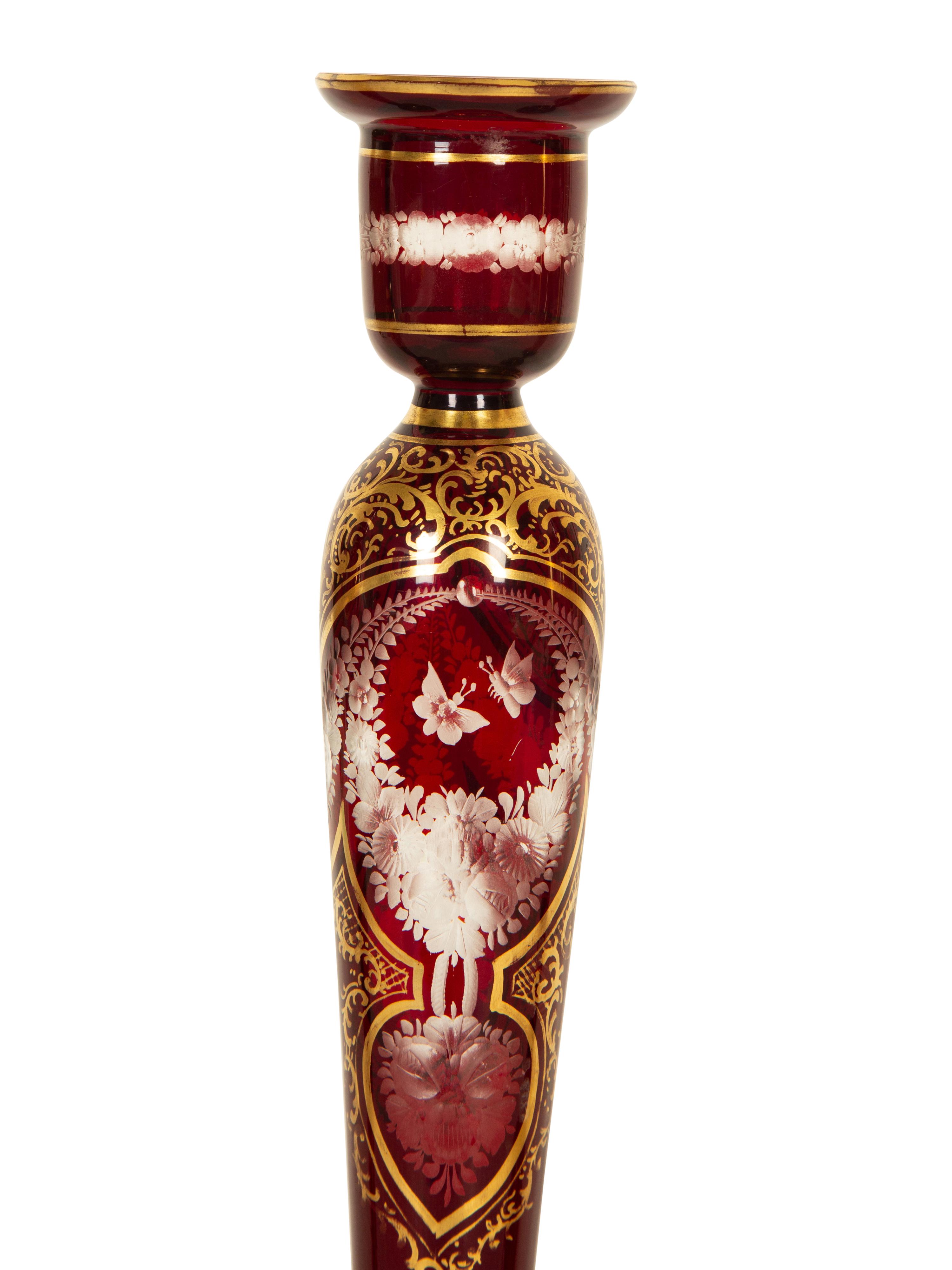 A Set of Four Bohemian Ruby Cut-to-Clear Glass Candlesticks with Gilt Decoration. — 19th Century
