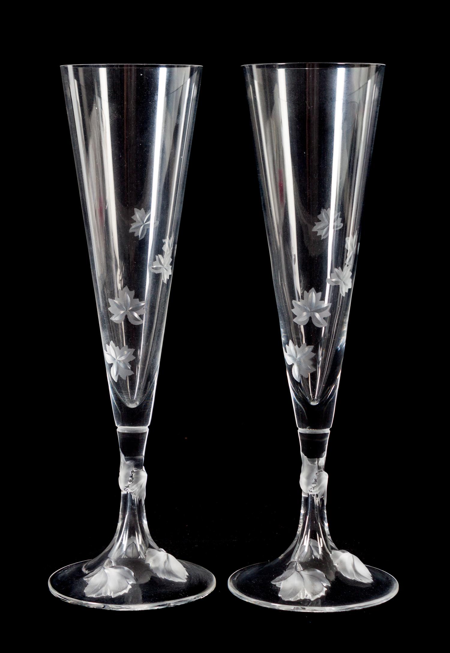 A Set of Twelve Lalique Molded and Frosted Glass Champagne Flutes Height 10 inches. — 20TH CENTURY