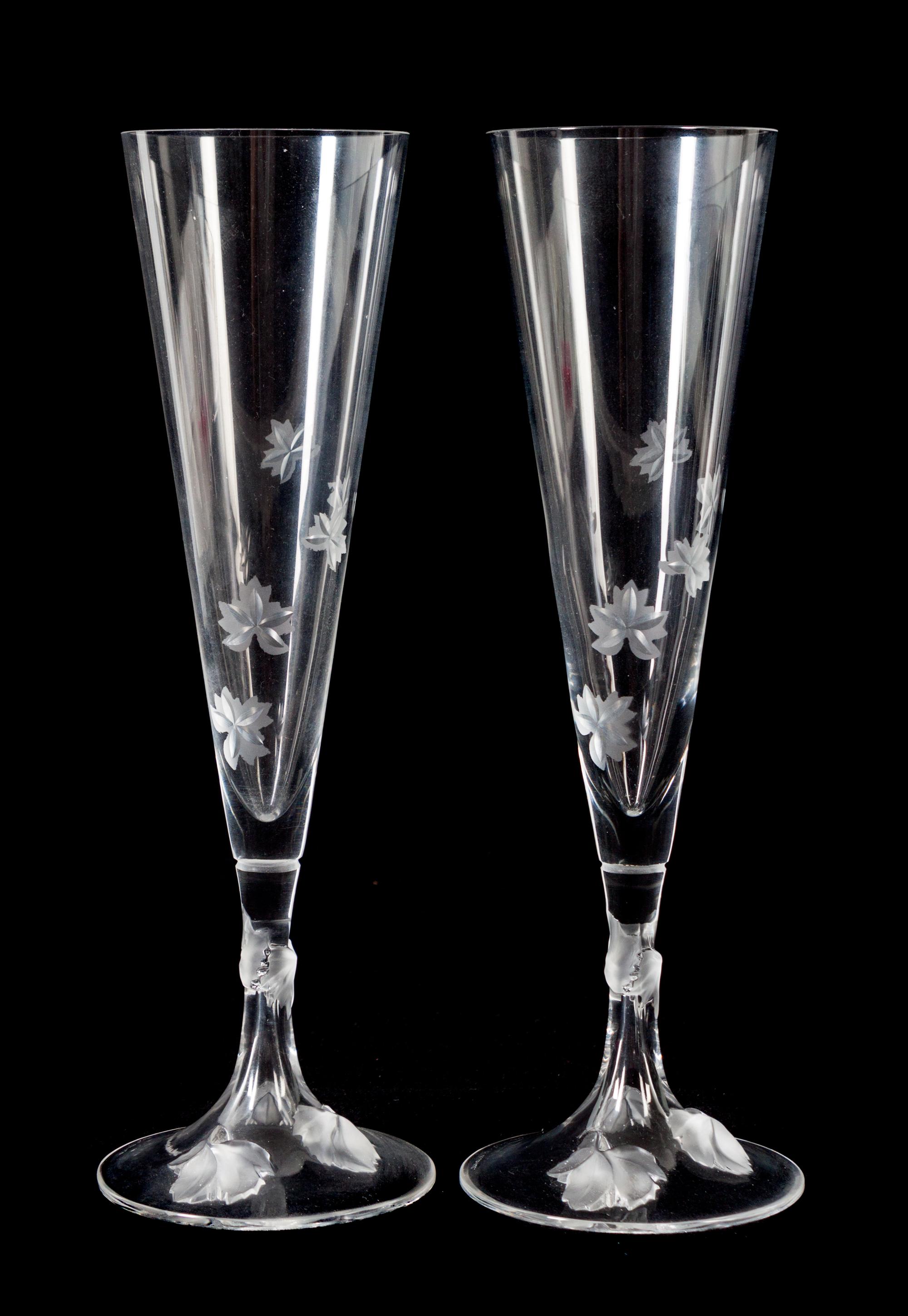 A Set of Twelve Lalique Molded and Frosted Glass Champagne Flutes Height 10 inches. — 20TH CENTURY