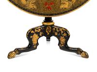 A Regency Style Lacquered and Gilt Decorated Tilt Top Tea Table