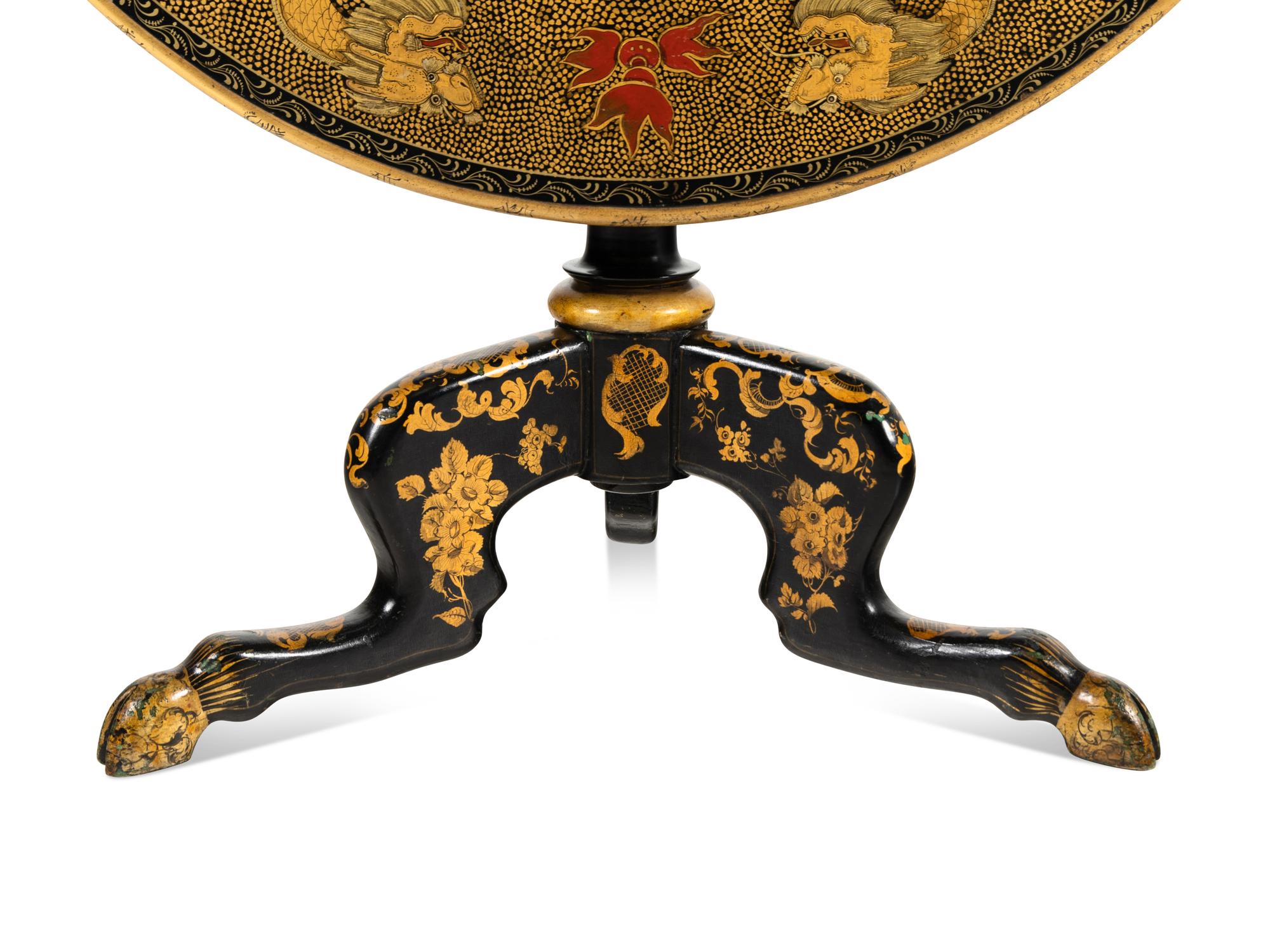 A Regency Style Lacquered and Gilt Decorated Tilt Top Tea Table