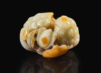 A Chinese carved pale celadon and russet jade "Lotus" group, Qing dynasty 青白玉荷蓮玉雕 清
