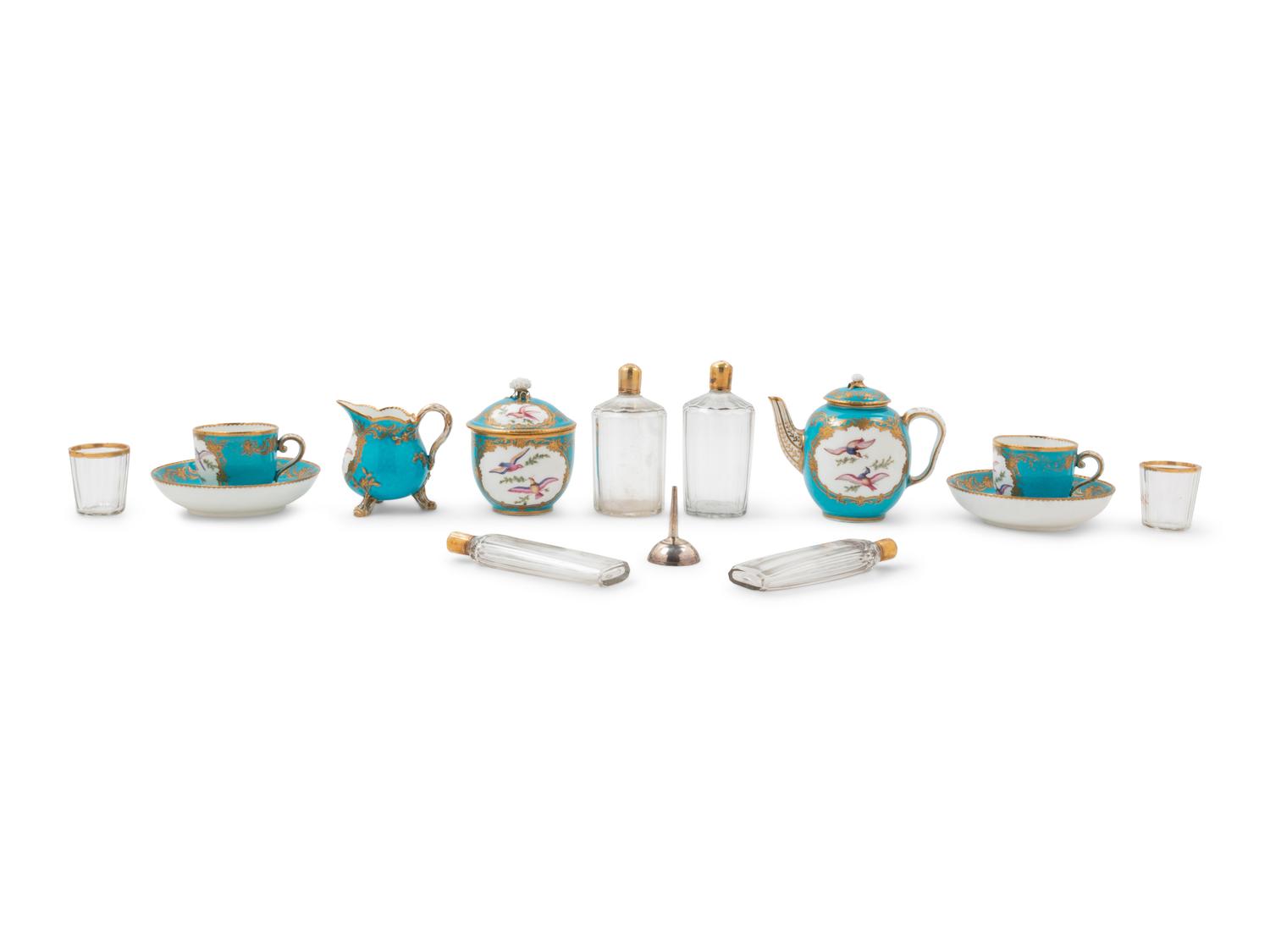 A Sèvres Painted and Parcel Gilt Porcelain Tea and Cordial Service in a Fitted Kingwood and Parquetry Traveling Case