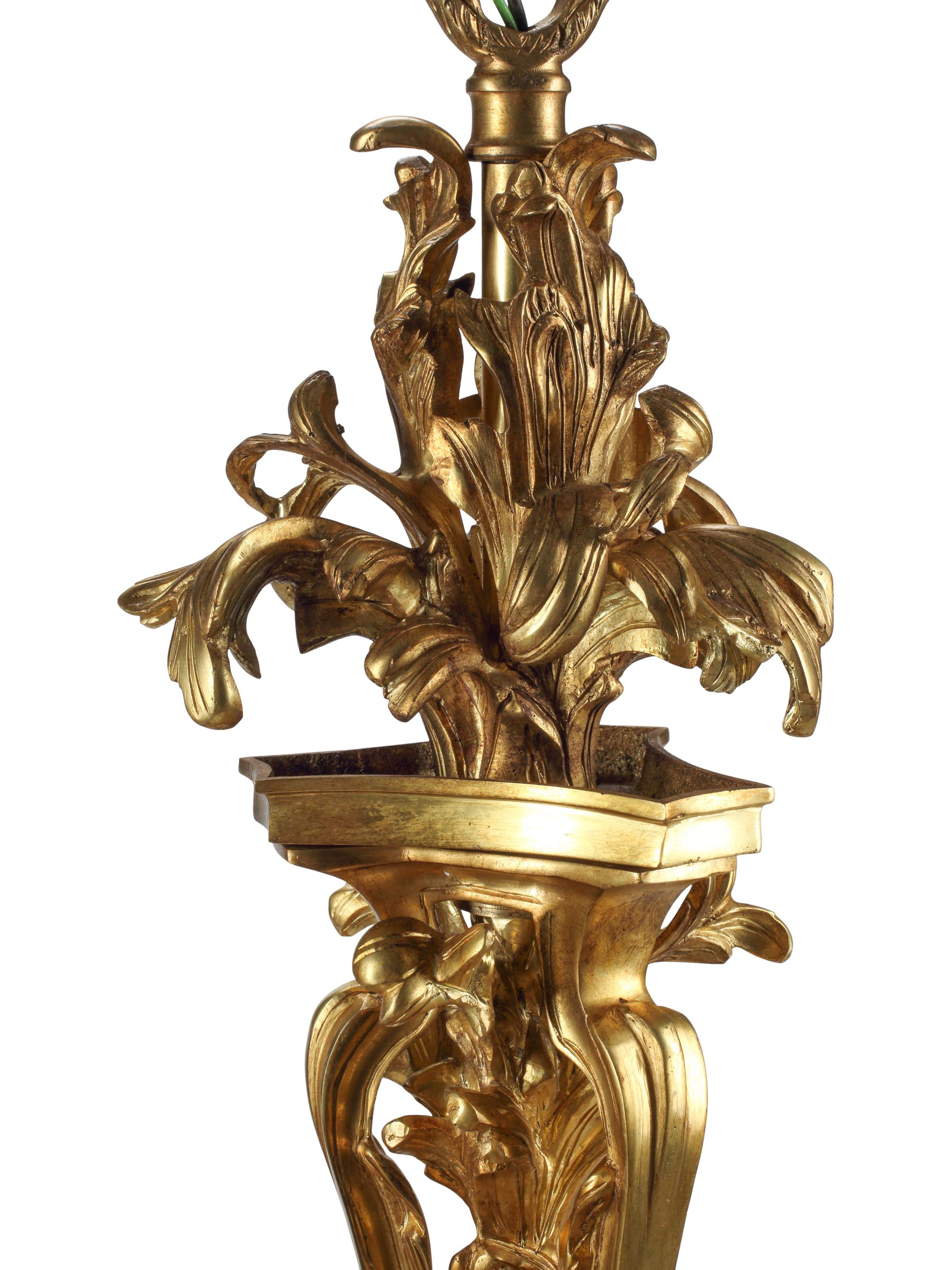 A Louis XV Style Gilt and Patinated Bronze Nine-Light Chandelier