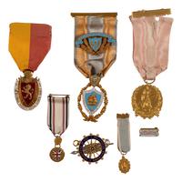 [AMERICANA]. A group of 7 badges identified to Colonial Dames, Daughters of the American Revolution, and other organizations, most 14K gold.