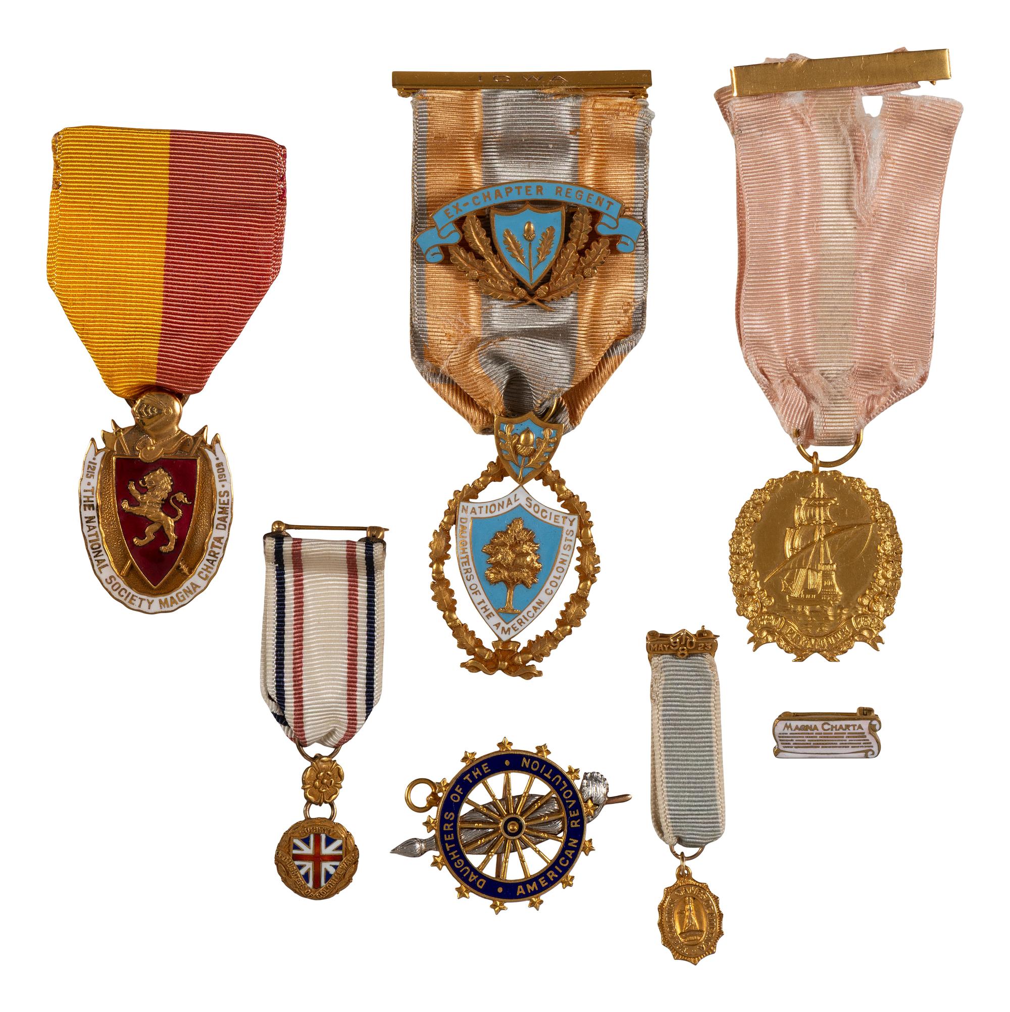 [AMERICANA]. A group of 7 badges identified to Colonial Dames, Daughters of the American Revolution, and other organizations, most 14K gold.