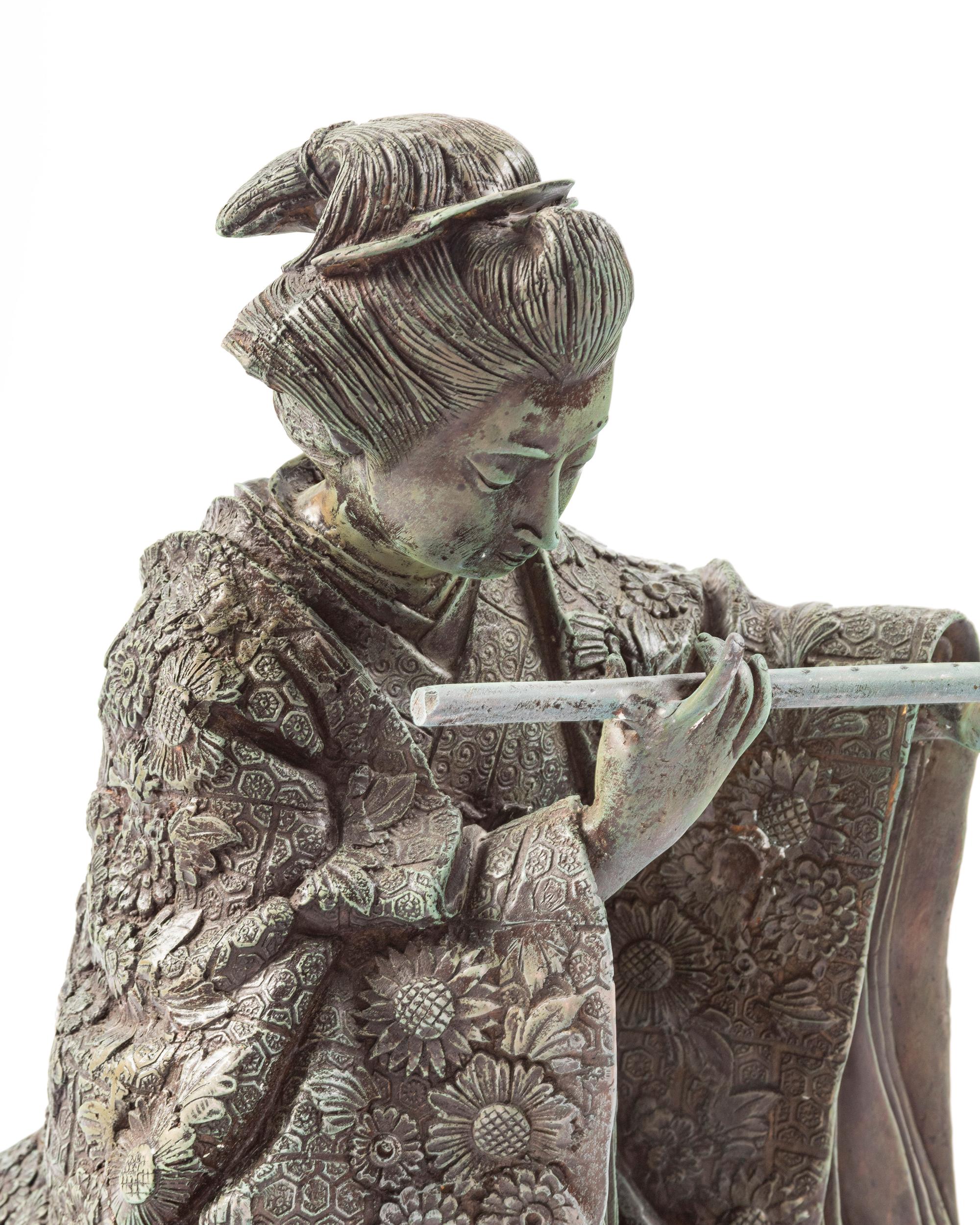 A Japanese Bronze Figure of a Woman Playing the Flute