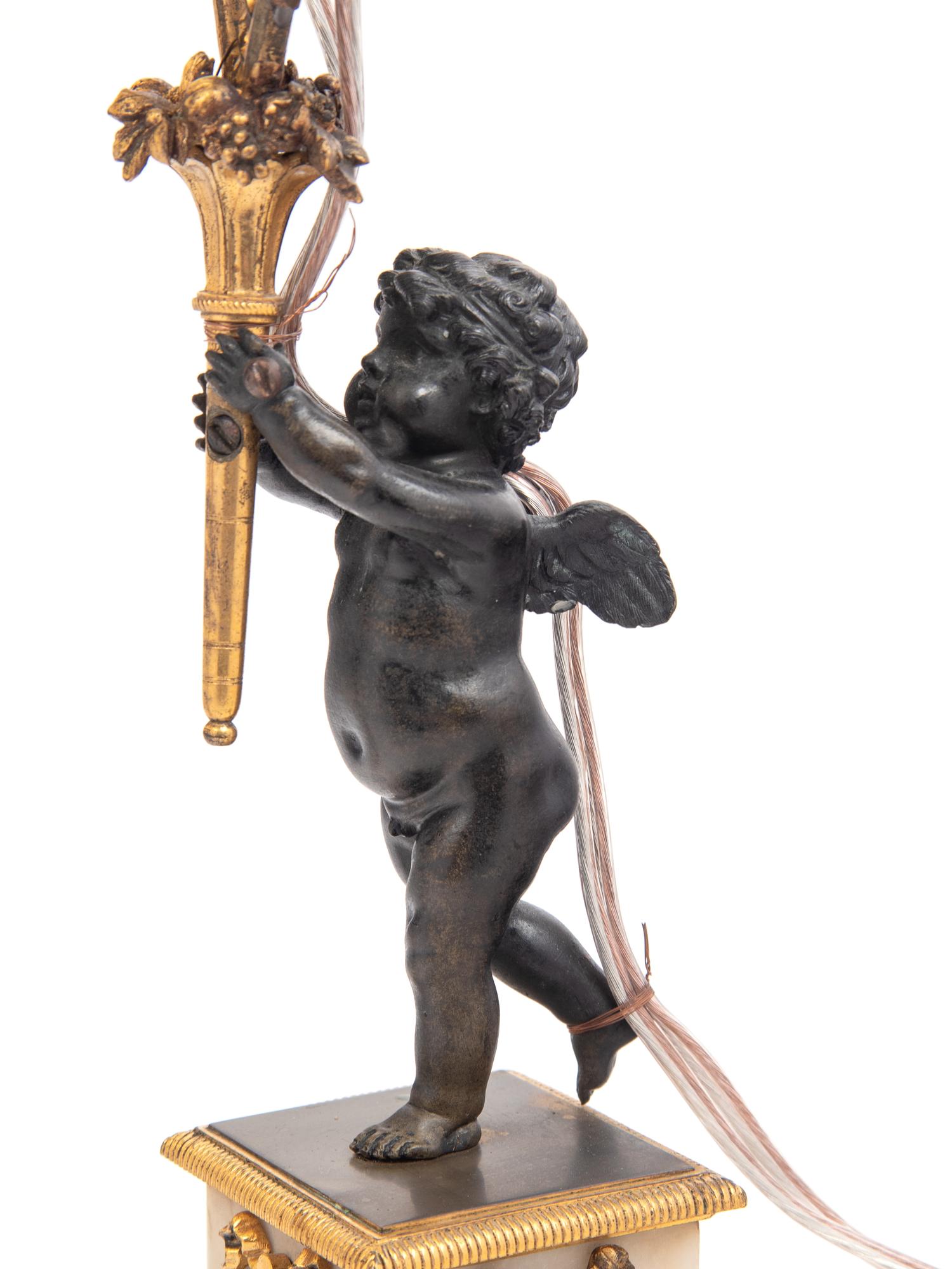 A Pair of French Gilt Metal and Marble Figural Two-Light Candelabra