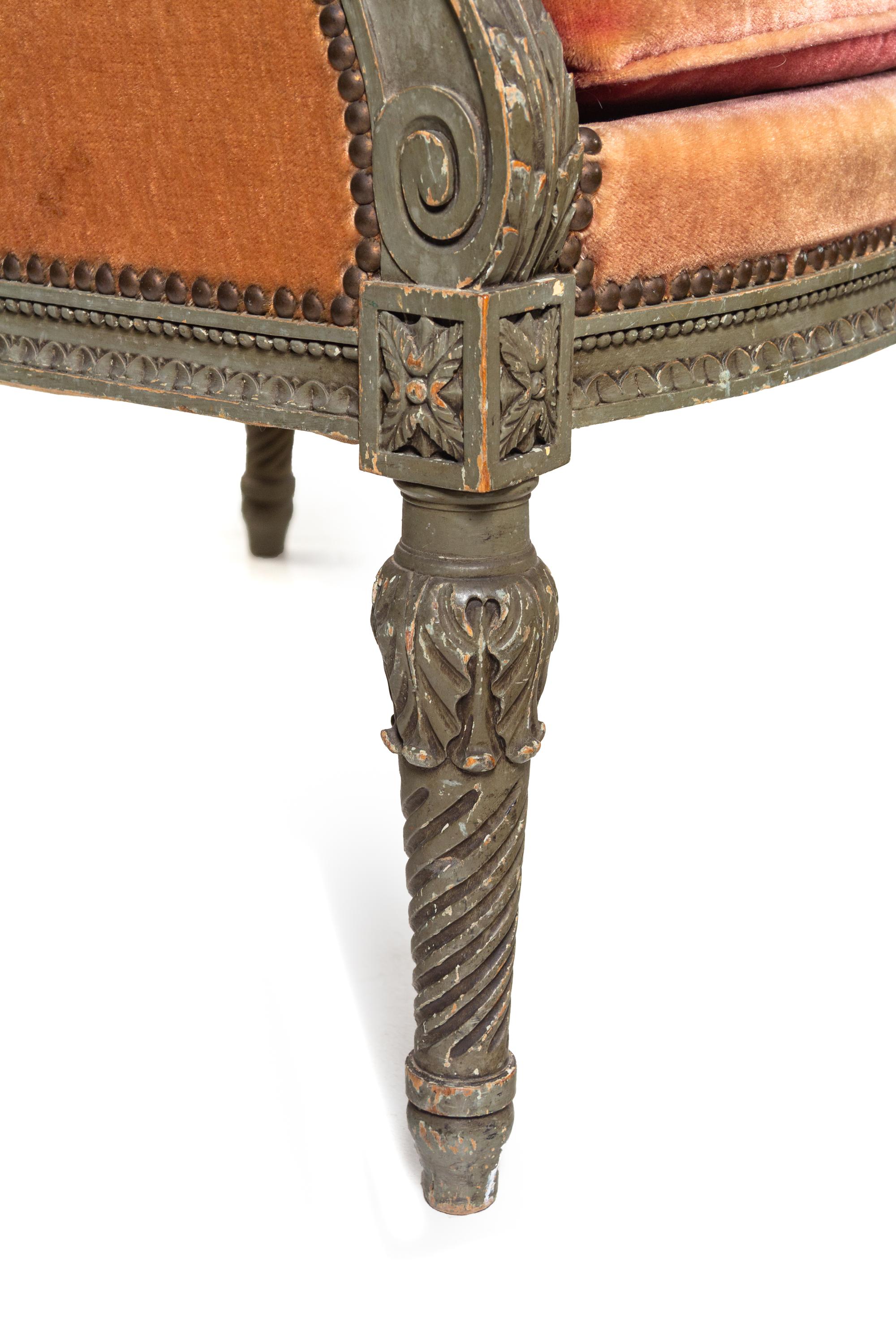 A Pair of Louis XVI Carved and Painted Walnut Bergères à L'Oreilles