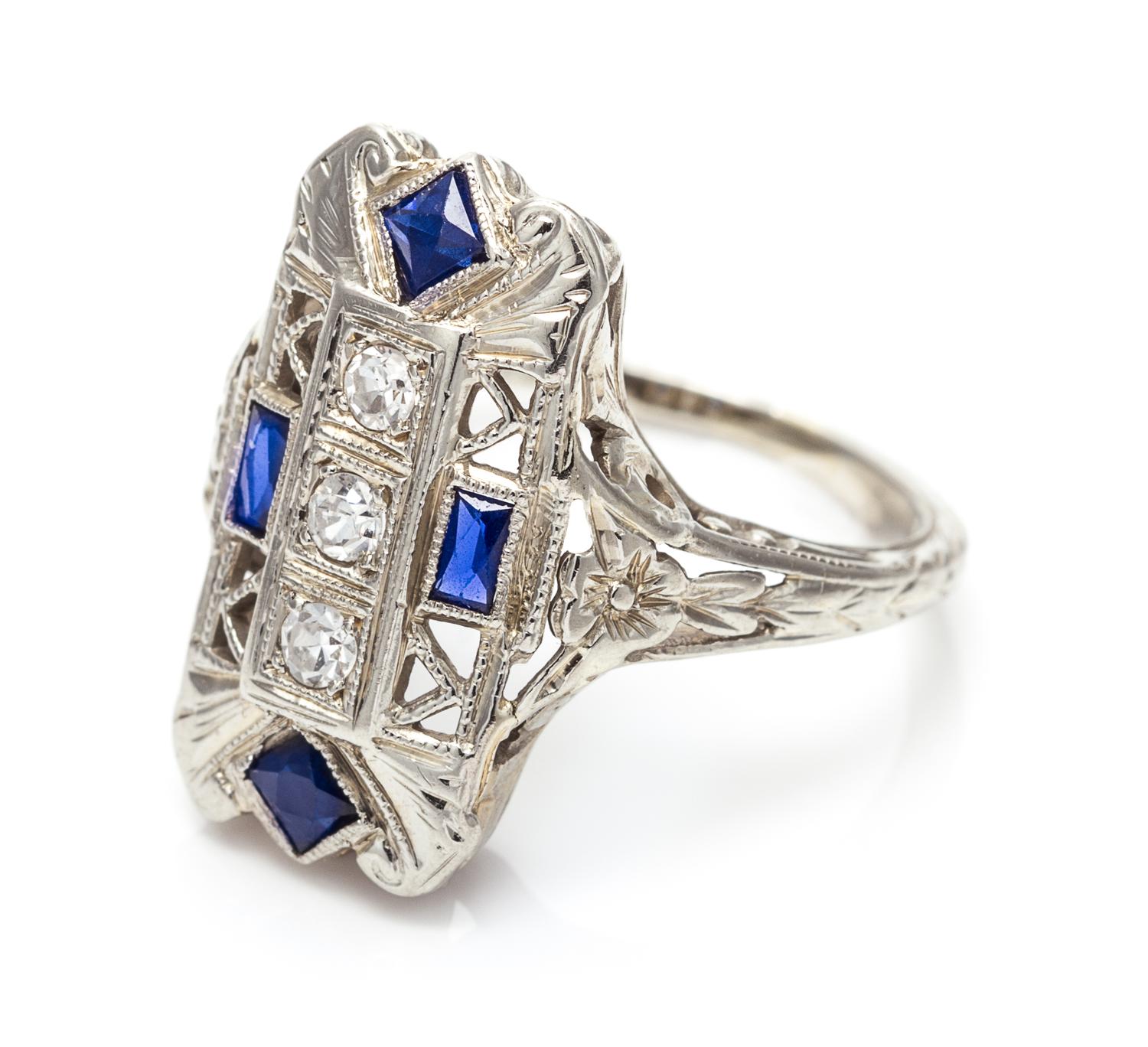 An 18 Karat White Gold, Diamond and Synthetic Sapphire Ring, 2.20 dwts.