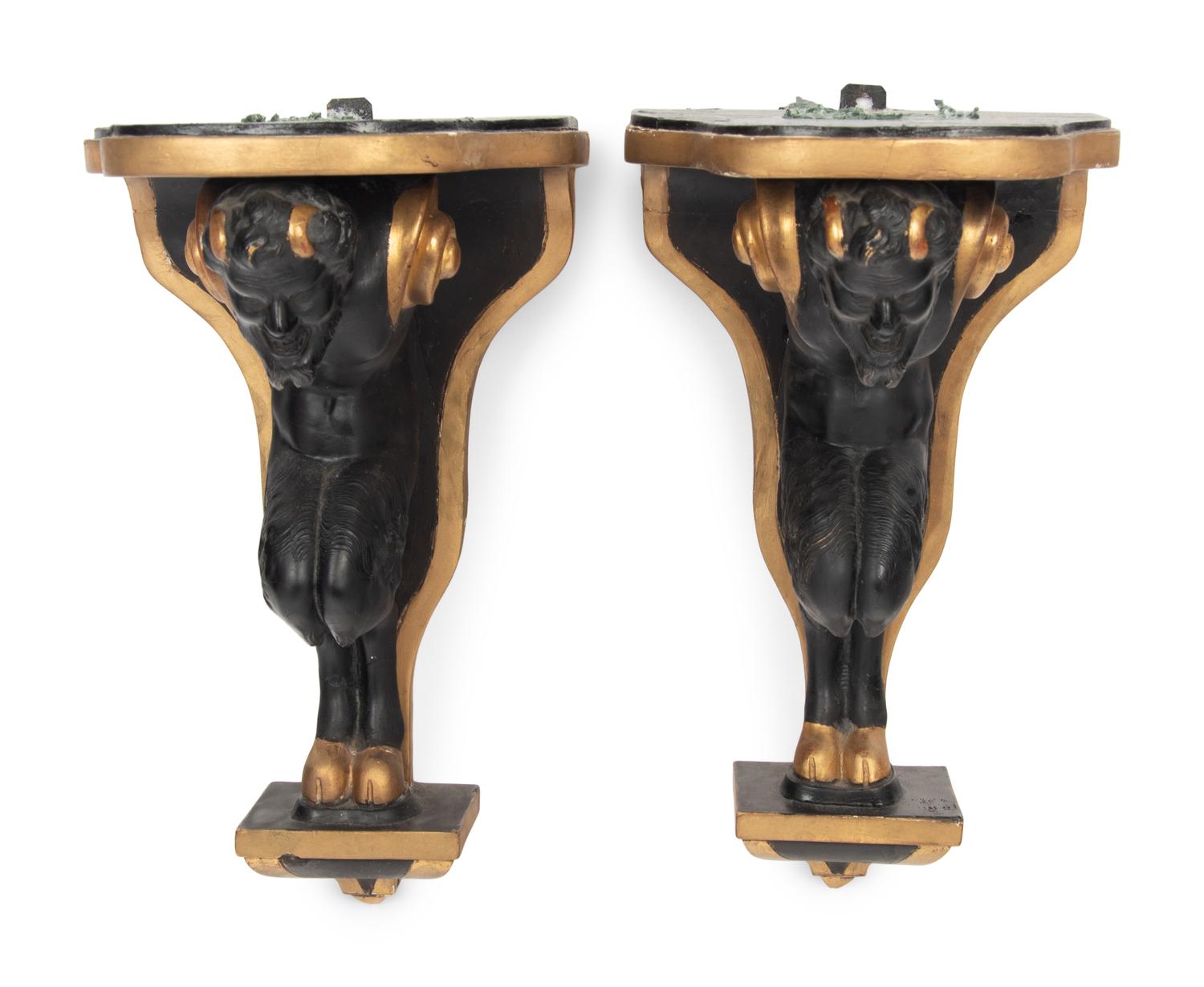 A Pair of Continental Ebonized and Parcel Gilt Wood Figural Brackets