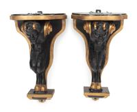 A Pair of Continental Ebonized and Parcel Gilt Wood Figural Brackets