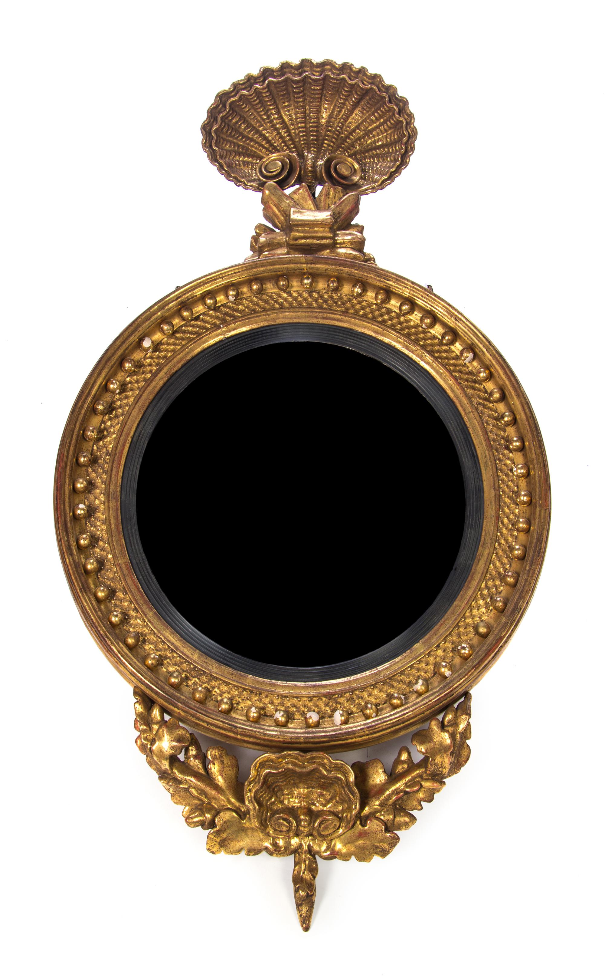 A Regency Giltwood Bull's Eye Mirror, Height 44 x width 25 1/2 inches.