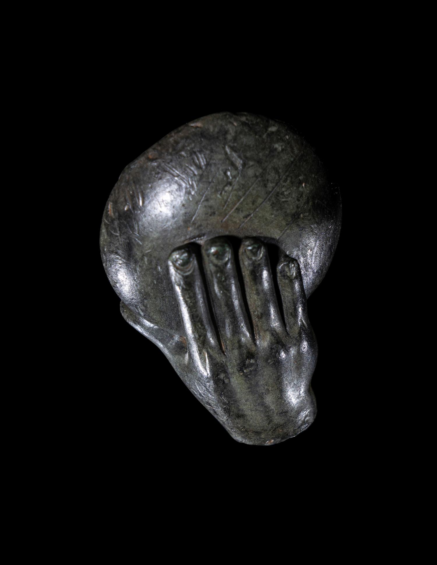 A Greek Bronze Hand of a Satyr Holding a Phiale