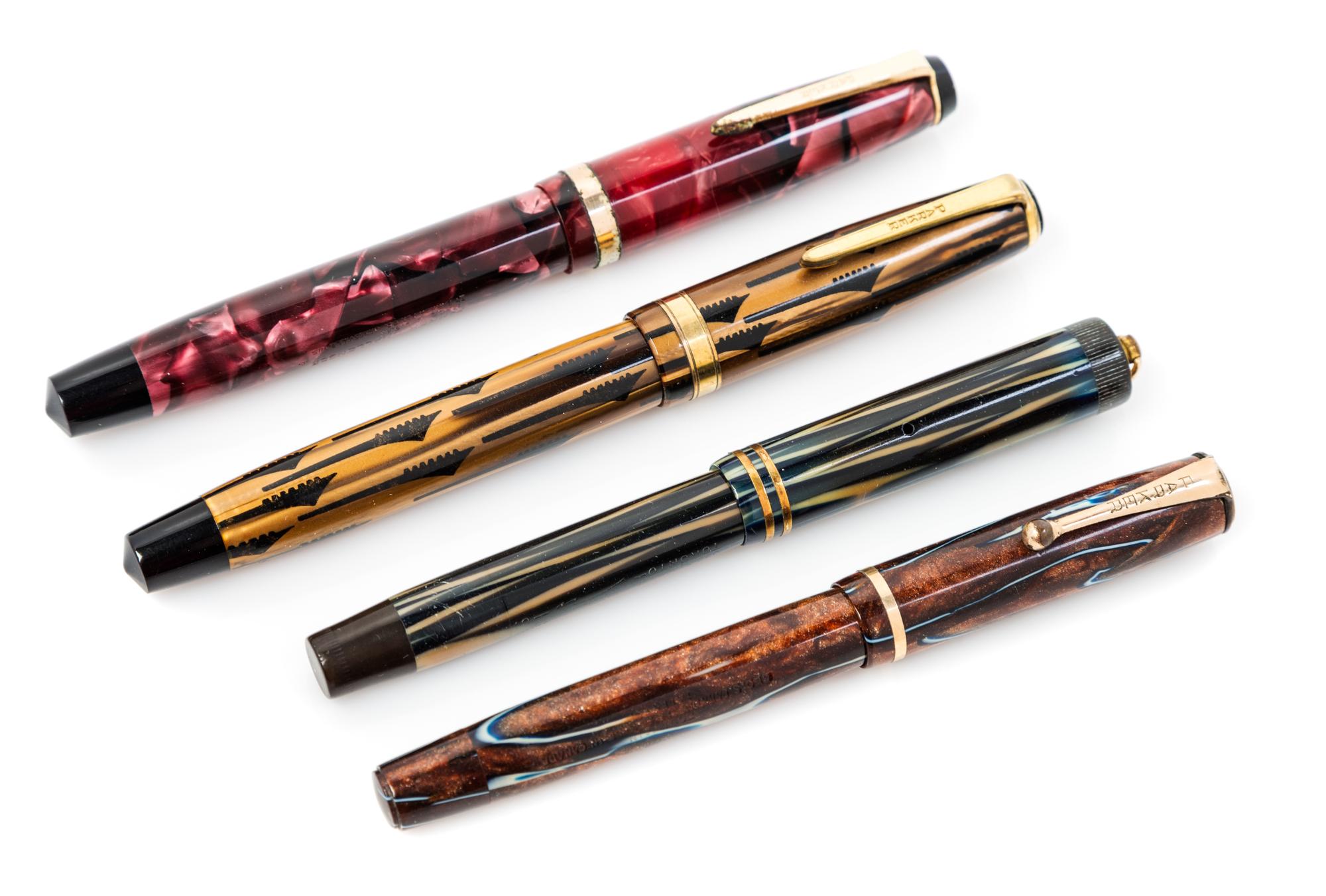 A Group of Four Parker Fountain Pens Length of longest 5 1/8 inches.