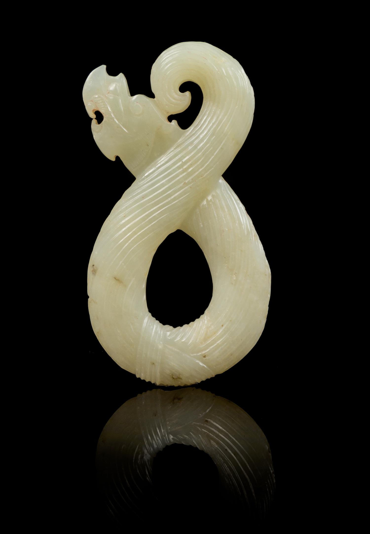 A Carved Jade Pendant Length 3 1/8 inches.