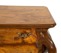 A Continental Gilt Metal Mounted Olivewood and Mahogany Bombé Commode