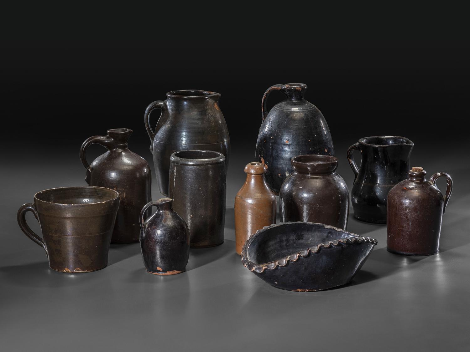 Eleven Albany Slip Stoneware and Redware Vessels