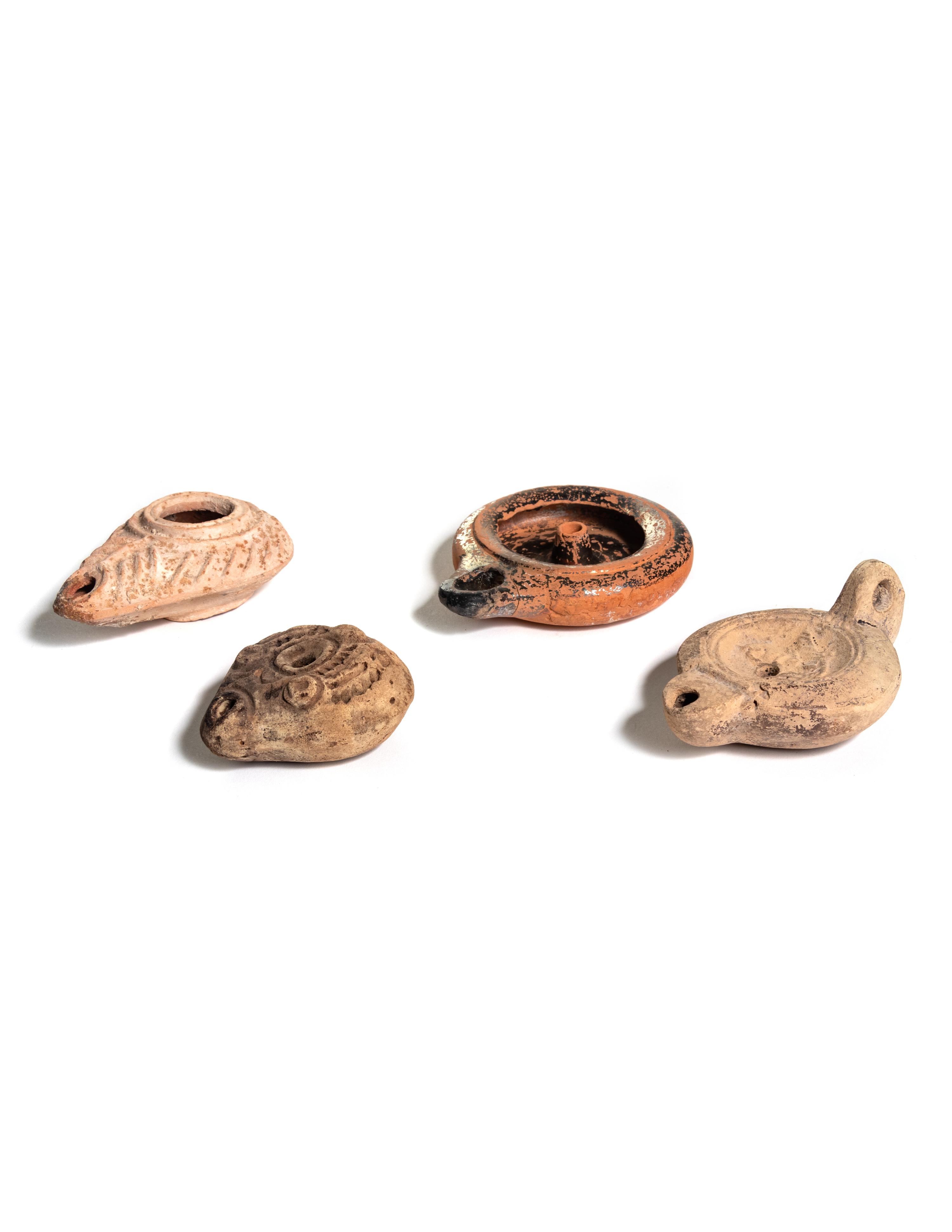 Four Roman Molded Terra Cotta Oil Lamps