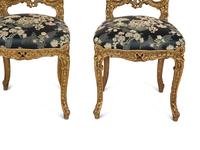 A Set of Four French Rococo Style Carved Gilt Wood Side Chairs