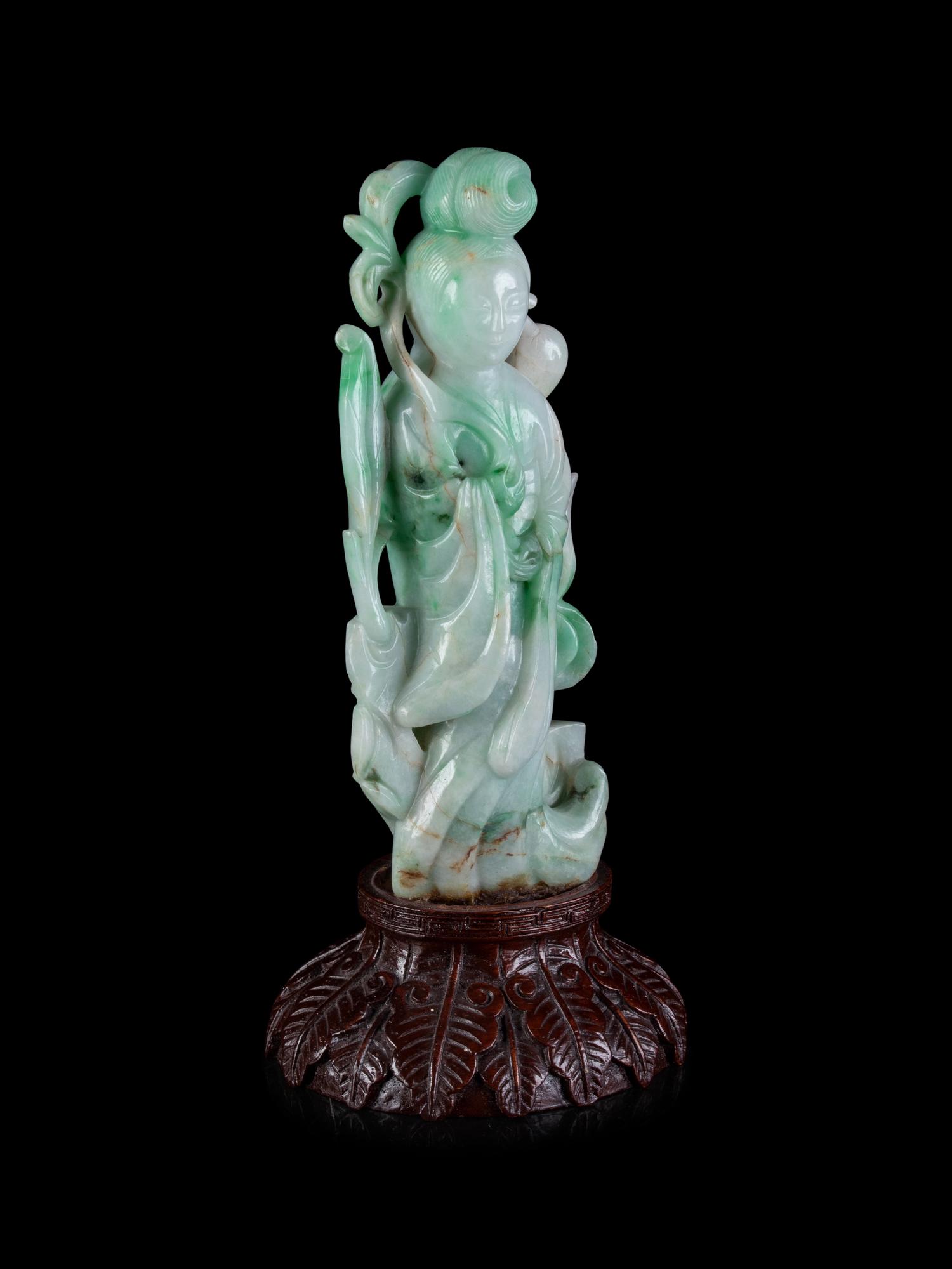 A Chinese Apple Green and Pale Celadon Jadeite Figure of Guanyin
