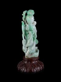 A Chinese Apple Green and Pale Celadon Jadeite Figure of Guanyin