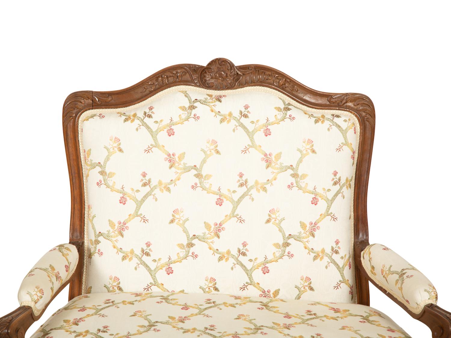 A Pair of Louis XV Style Carved Mahogany Fauteuils