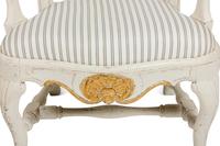 A Pair of Swedish White-Painted and Parcel-Gilt Open Armchairs
