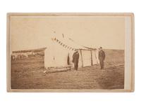 [CIVIL WAR]. CDV of a photographer's tent reading "AMBROTYPES," with the likely photographer and an officer standing just outside. Alexandria, VA: Gorman & Jordan, ca 1864.