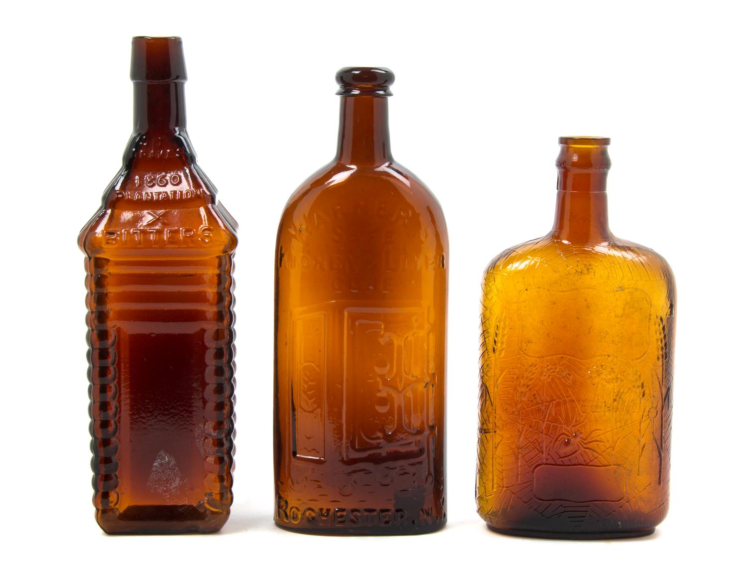 Three American Brown Glass Bottles, Height of tallest 10 1/4 inches.