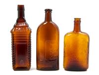 Three American Brown Glass Bottles, Height of tallest 10 1/4 inches.