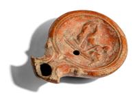A Roman Terracotta Lamp with Symplegma Scene