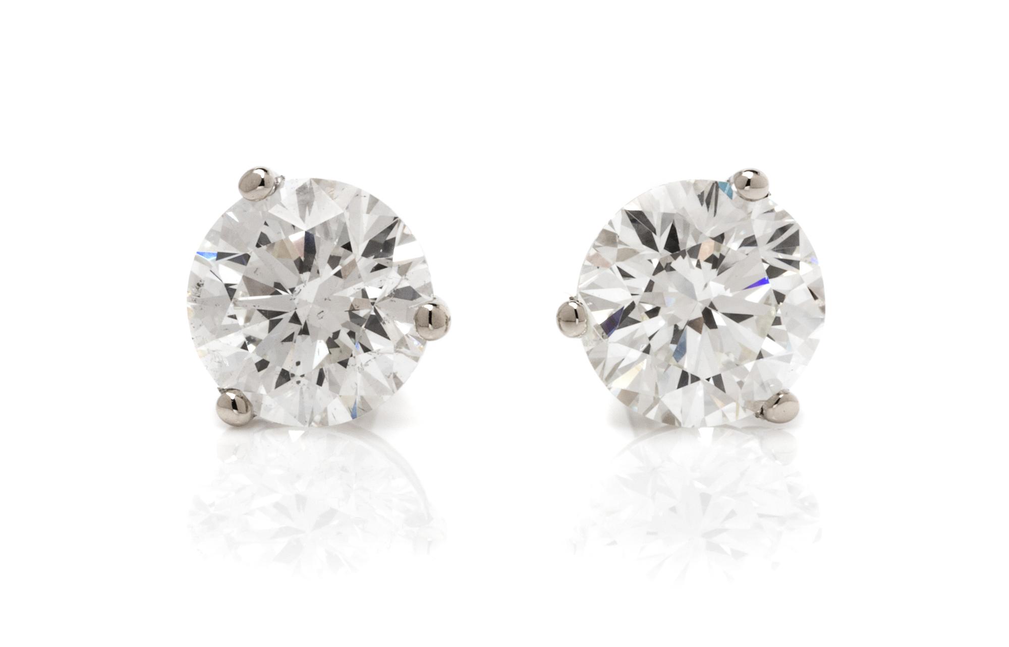 A Pair of 14 Karat White Gold and Diamond Stud Earrings, 0.60 dwts.