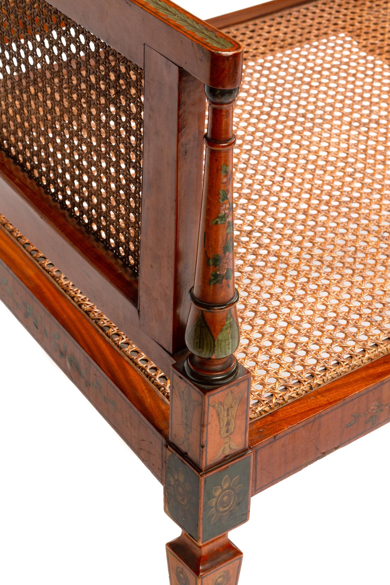 An Edwardian Painted Satinwood Caned Settee