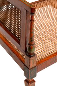 An Edwardian Painted Satinwood Caned Settee